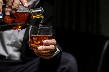 Closeup businessmen holding a glass of whiskey