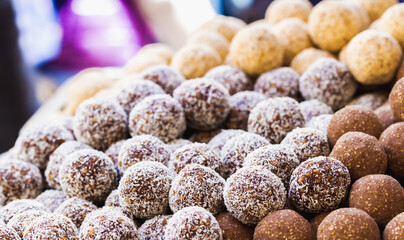 Heap of different chocolate round candies in the market