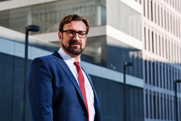 Portrait of an elegant businessman looking at the camera outdoors