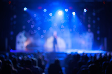 Fototapeta na wymiar Texture blur and defocus, background for design. Stage light at a concert show. Singers, musicians and dancers perform on scene.