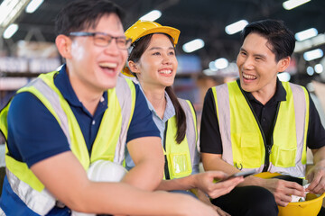 Staff in large storage warehouse together sit back relax funny laughing check mobile phone