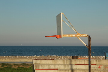 Basketball ring at a field near beach
