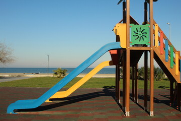 Fototapeta premium Blue and yellow slide at park