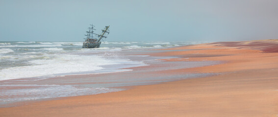 An old wooden ship sitting on top of a sandy beach