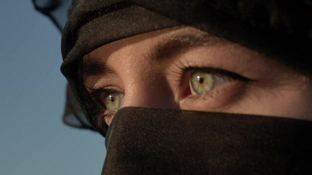 Young Muslim Woman in Hijab Open Her Green Eyes, Revealing Pan View