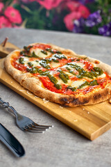 Fresh baked focaccia or pizza with mozzarella and pesto.