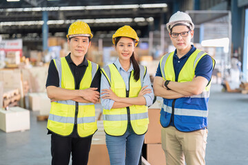 Staff in large storage warehouse together portrait after work completed hand on shoulder smiling