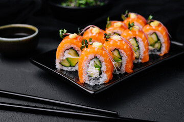 Philadelphia Sushi with avocado on black dish