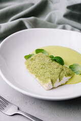 fried fish with basil sauce on plate