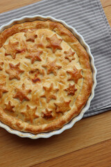 Italian Timballo or Timbale filled with pasta and bechamel with tomato sauce on wooden table