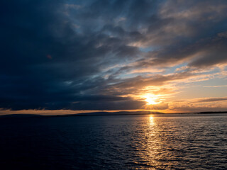 Obraz premium Stunning nature scene with sunset sky over ocean. Galway bay and Burren mountains in the background. Nobody. Irish landscape.