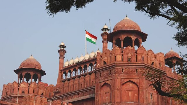 Red Fort Lal Qila with Indian flag flying. Delhi, India. Tricolor Flag of India with Sky in Background