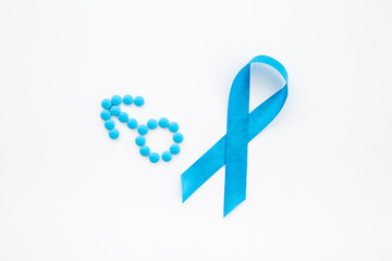 Blue ribbon symbol of prostate cancer with male sign of blue pills