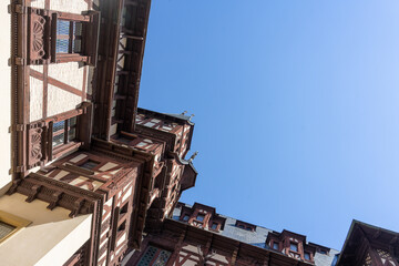 Looking up at an old building under a blue sky