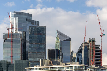 Obraz premium Modern steel and glass towers and buildings, multiple floored office spaces reaching for the sky in London, UK