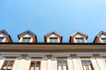 looking up at a building with an attic