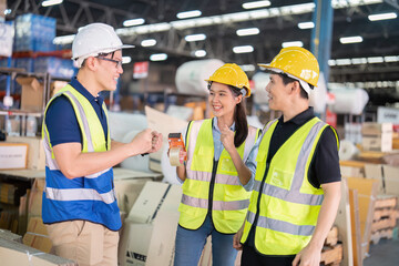 Staff in large storage warehouse together cheerful after work completed hand touching congrats