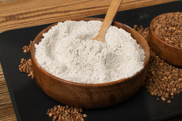 Buckwheat Flour Pile in Wood Bowl, Dry Buck Wheat Powder, Buckwheat Flour on Wooden Rustic Background