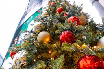 Decorated Christmas Tree, Christmas Decorations, Shiny Garland on Green Branches, Blurred Background