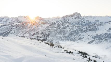 Fototapeta na wymiar Valley view of the Kleinwalsertal in winter with fresh snow and blue sky. Austria Allgäu Alps