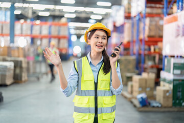 Staff in large storage warehouse use radio walkie talkie explain material storage location to team