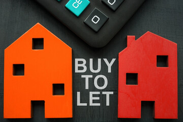 Models of house, calculator and inscription Buy to let BTL.