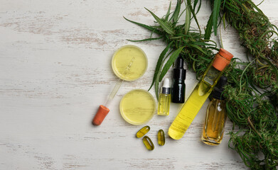 CBD oil hemp products,Flower bud of cannabis Satival,Plant of marijuana medical use with a high content of CBD on wood background