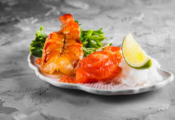 slice salmon fish and shrimp with salad on plate