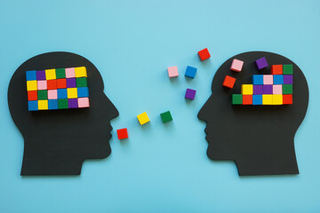 Heads with colorful cubes as symbol of mentoring and psychotherapy. - obrazy, fototapety, plakaty