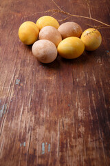 Colored easter eggs on brown rustic table. DIY Easter eggs coloring. Copy space, vertical shot