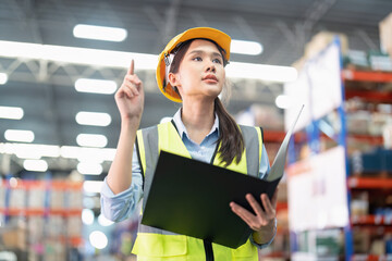 Staff working in large depot storage warehouse hold check list walking check goods on shelf