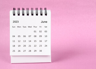 The June 2023 desk calendar on pink color background.