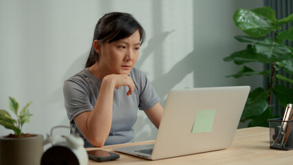 Asian woman working with computer tired and sleepy yawning at home office.