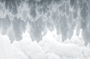 Pieces of snow, snow stalactites on the wall, winter, snowy growths, snow icicles