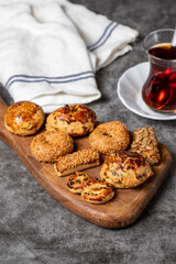 Salty cookies on a dark background. Types of sesame and seed cookies on a wooden serving plate. close up