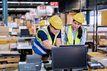 Fototapeta premium Staff working in large depot storage warehouse trainee check packing box and scan at cashier counter