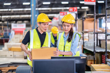 Staff working in large depot storage warehouse trainee check packing box and scan at cashier counter