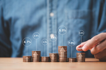 Businessman stacking coins in different height with percentage for interest rating from differ investment , Financial profit return and dividend concept. - obrazy, fototapety, plakaty