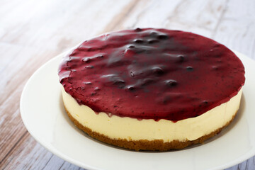 Sweet cheesecake with blue berry on wooden table