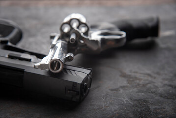Gun with ammunition and shackle on black background. 
