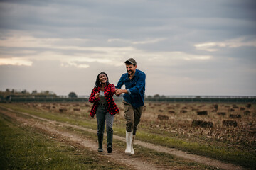 Shot of a loving young couple having fun outdoors in a grass field. Man and woman enjoying a day in a meadow.