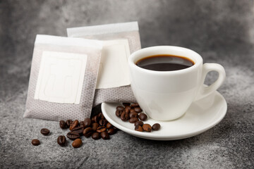 Making drip coffee with a special taste. Drip coffee bag in a coffee cup. Trends in brewing coffee at home.
