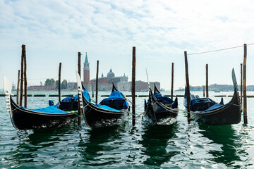 Fototapeta na wymiar Gondolas in Venice, Italy. Water parking for boats.