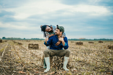 Loving farmer couple spending time in the countryside, smiling and enjoying the village.