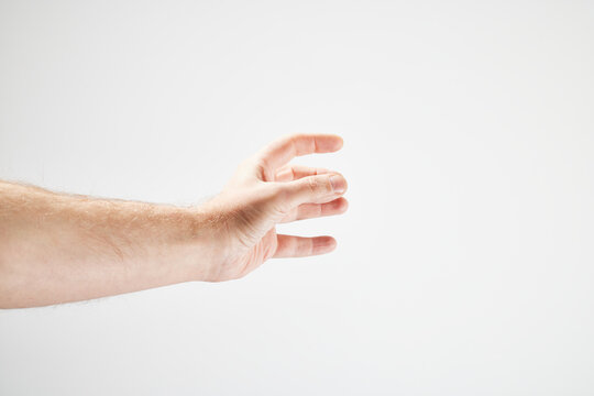 Male hand in front of white background