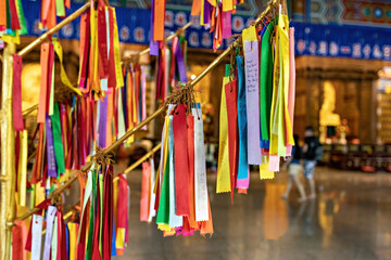 Fototapeta na wymiar Wish ribbons in Buddhist temple in Kek Lok Si temple, George Town, Penang, Malaysia. Translation: Love, Money, Success