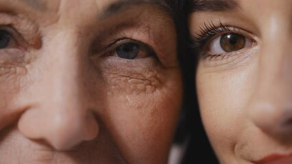 Closeup of smiling woman and her adult daughter, aging process, generations