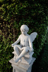 Statues in various postures placed in the garden