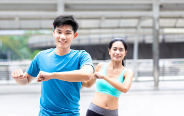 happy and healthy man and woman athlete runner exercise warm up together before outdoor jogging and running workout or run in city