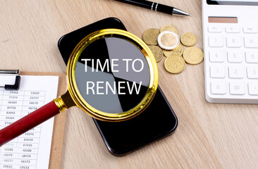 TIME TO RENEW text on the magnifier with smartphone, calculator and coins